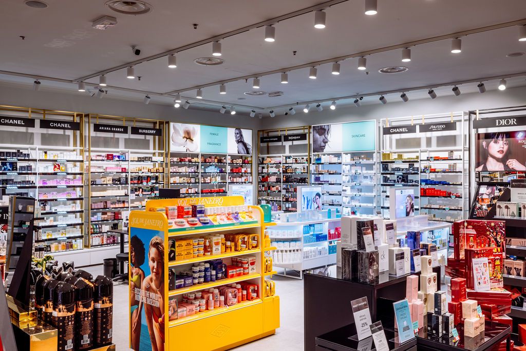 Modern retail store interior with bright lighting and shelving displays showcasing merchandise and products.