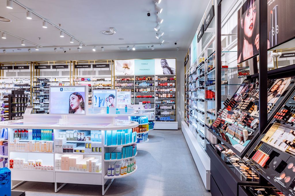 Wide angle panoramic view of a modern retail pharmacy store interior with bright lighting and stocked shelves.