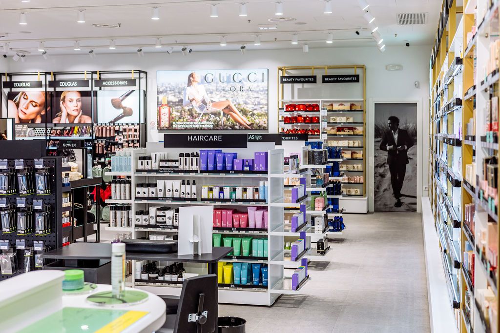 Modern pharmacy interior with bright lighting, stocked shelves, and clean aisles displaying healthcare products and medications.