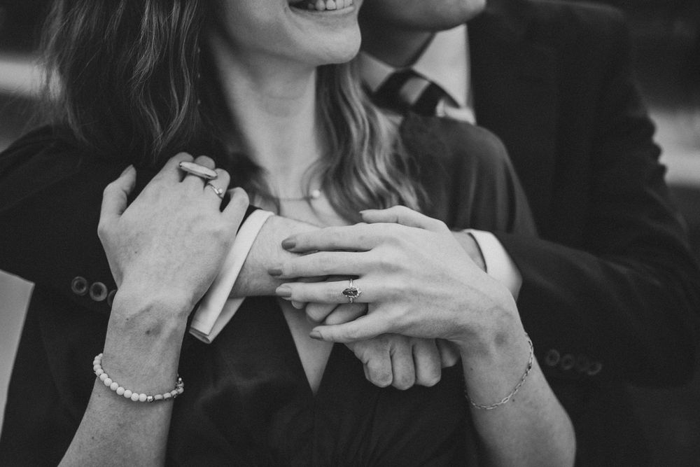 Black and white wedding photos showing couples embracing and laughing together during intimate moments.