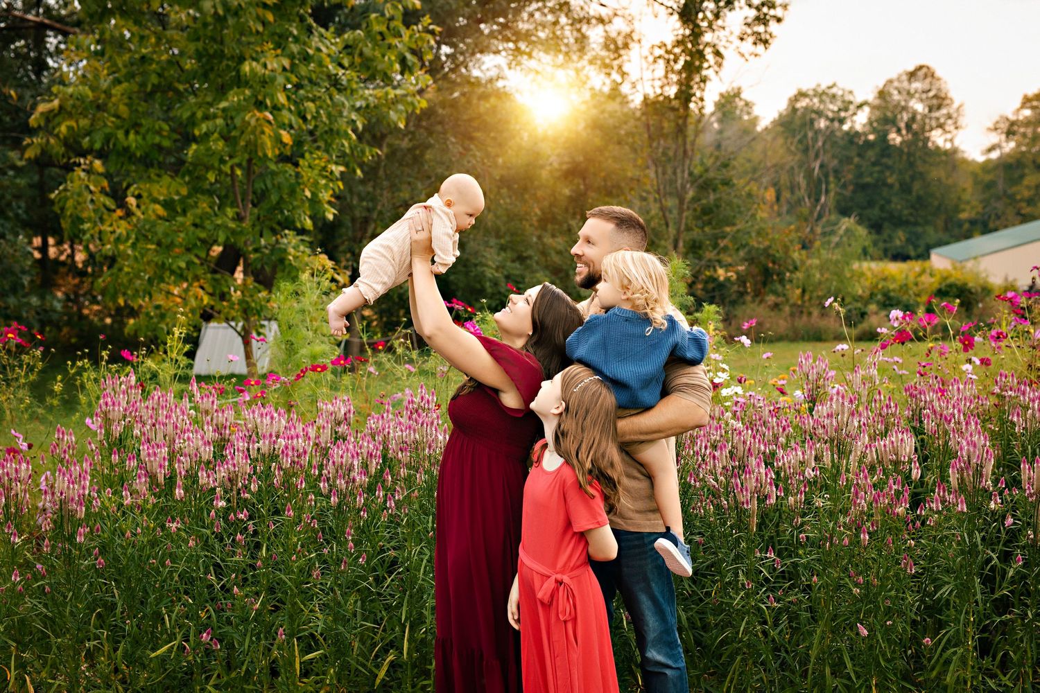 Family posed together among colorful flowers during summer mini photo sessions at First Roots Flower Farm in Oconomowoc, Wisconsin.