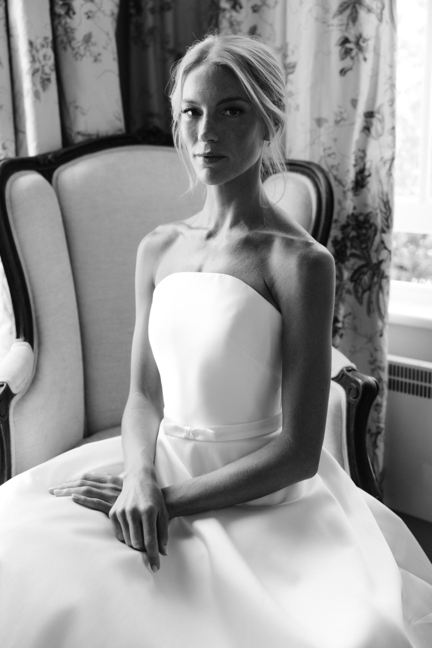 Black and white photo series showing close-up details of a bride in a strapless white wedding dress.