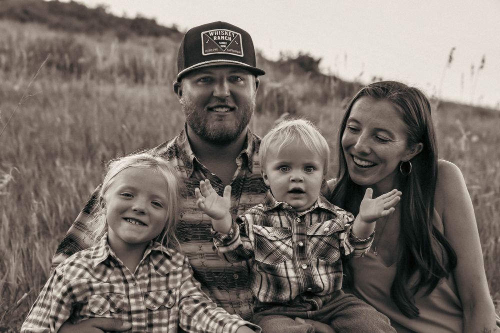 Happy family enjoying outdoor photo session in black and white.