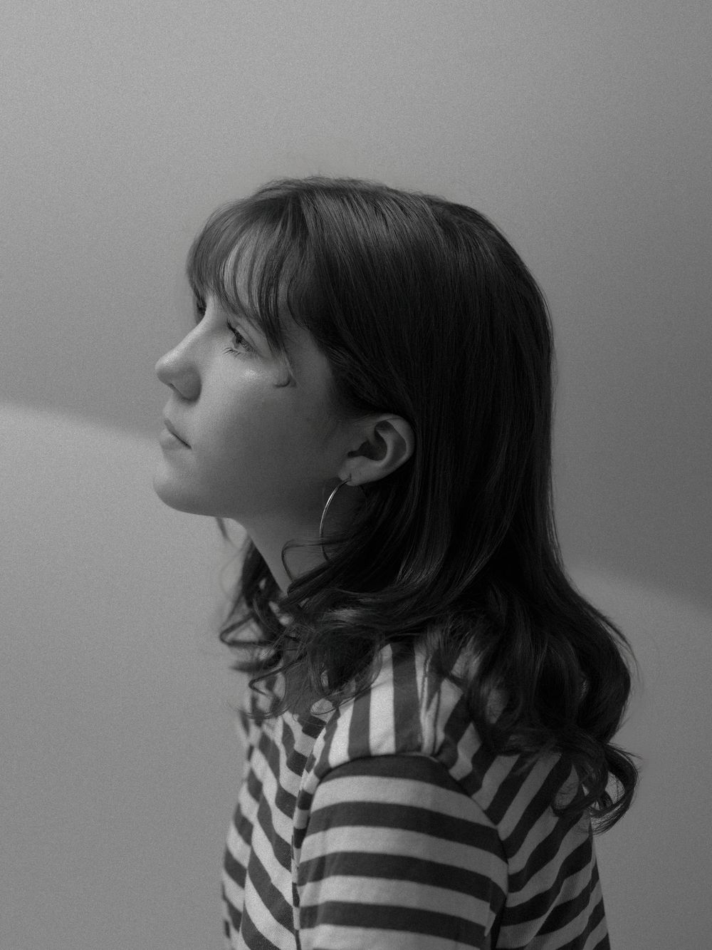 A black and white sequence of profile views showing a person in a striped shirt looking up at different angles.