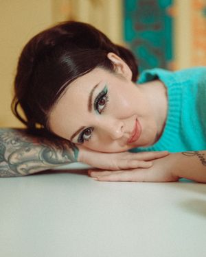 A series of artistic portrait photos showing a person with dark hair resting their head against a turquoise background.