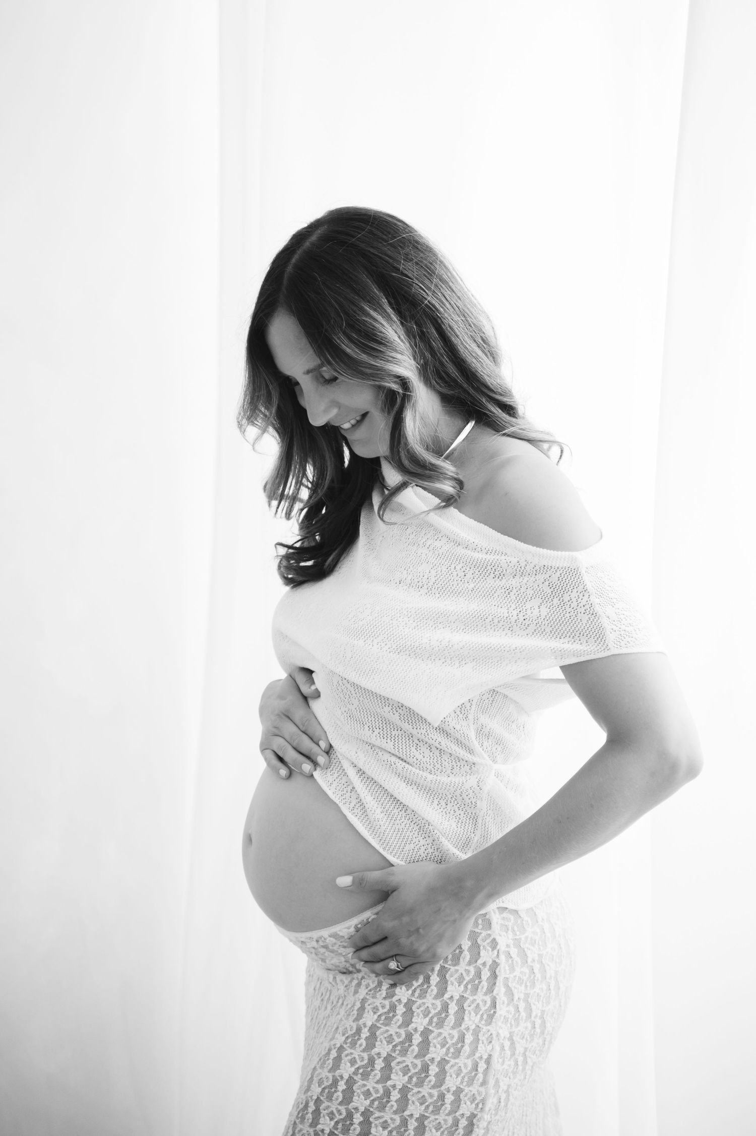 A person wearing a cozy grey off-shoulder sweater shown from multiple angles in a series of photos. Bump to baby package in Scotland.