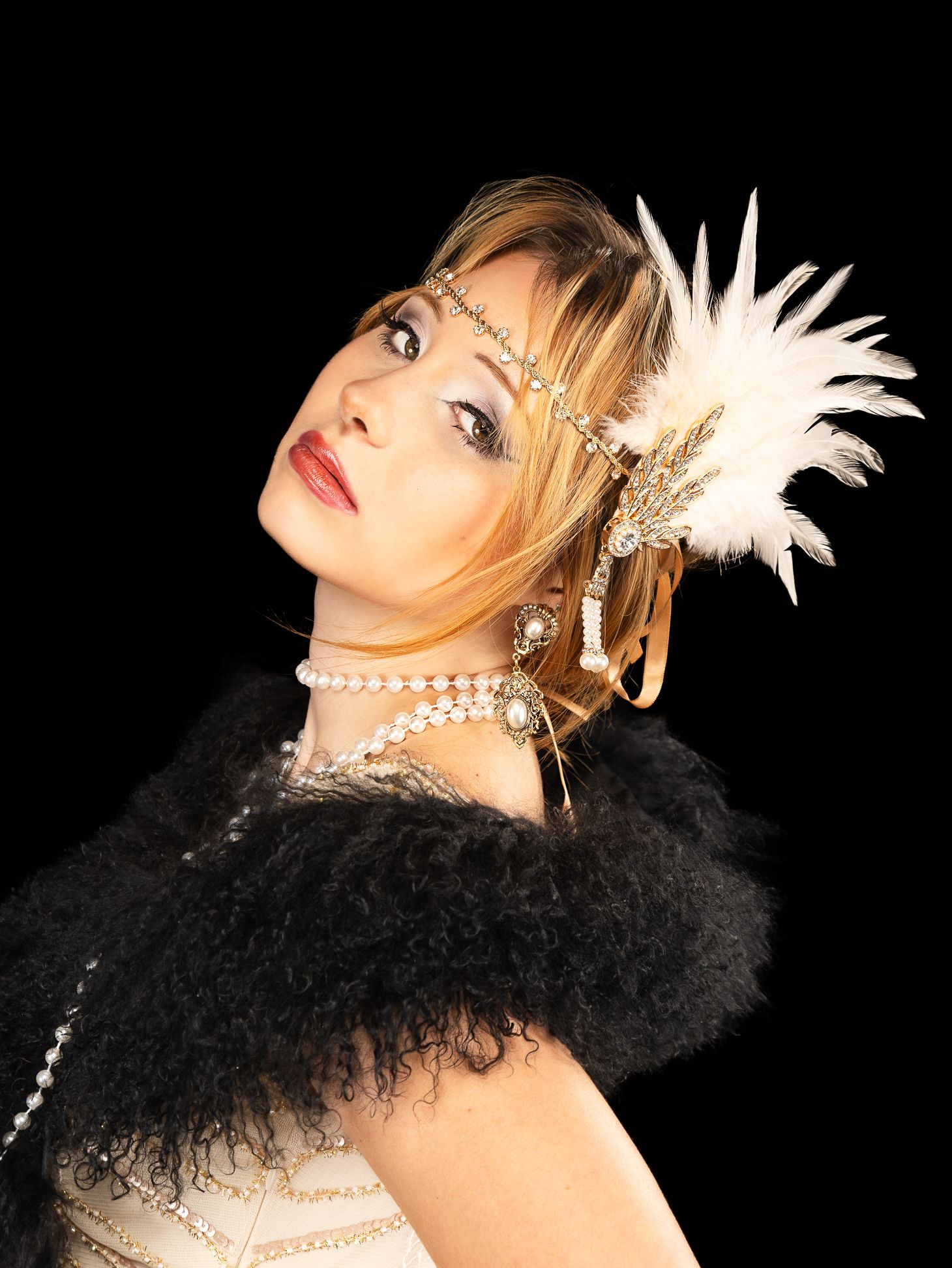 Colour photo of a girl in a flapper costume, looking direct