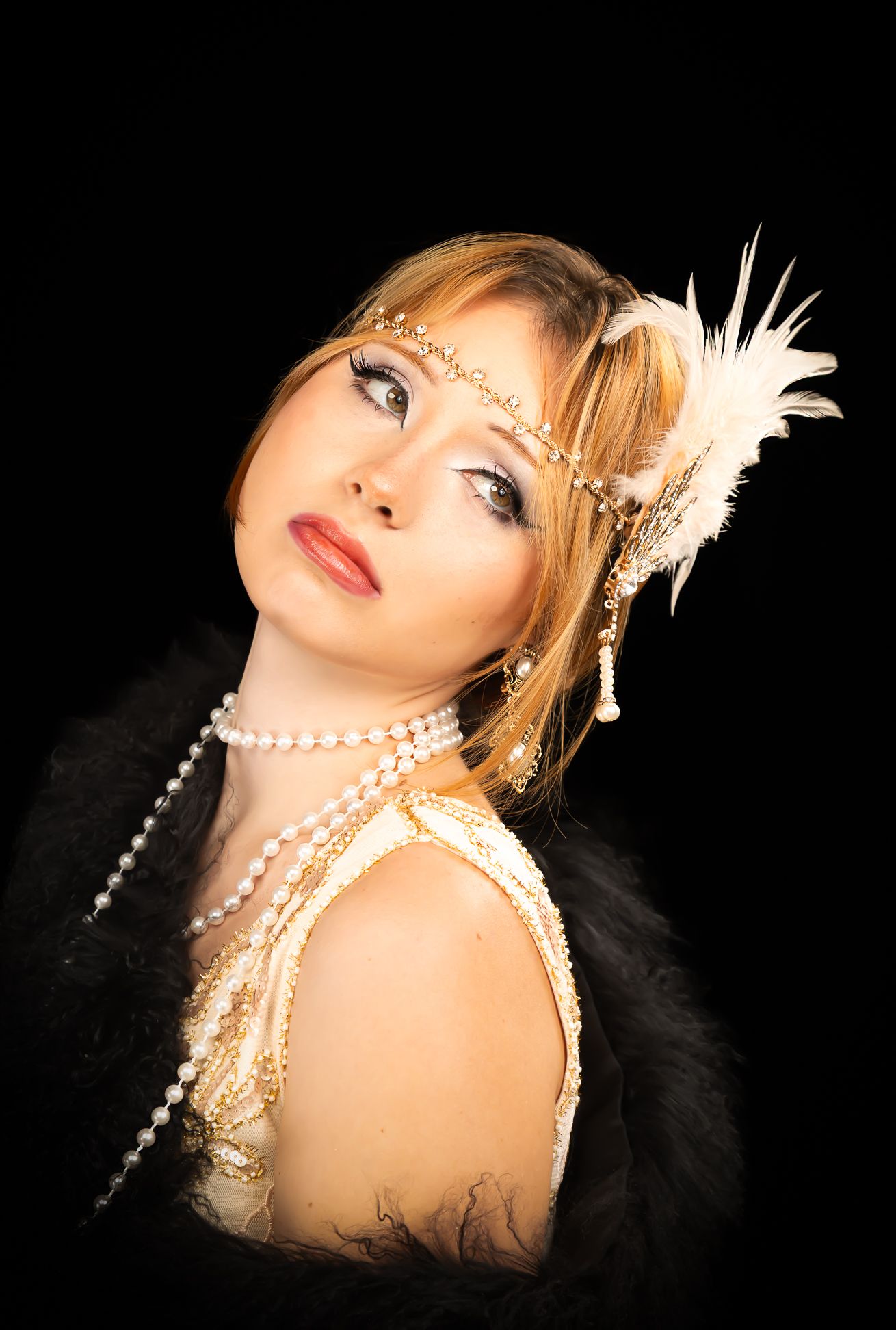 Colour photo of a girl in a flapper costume, looking up and right