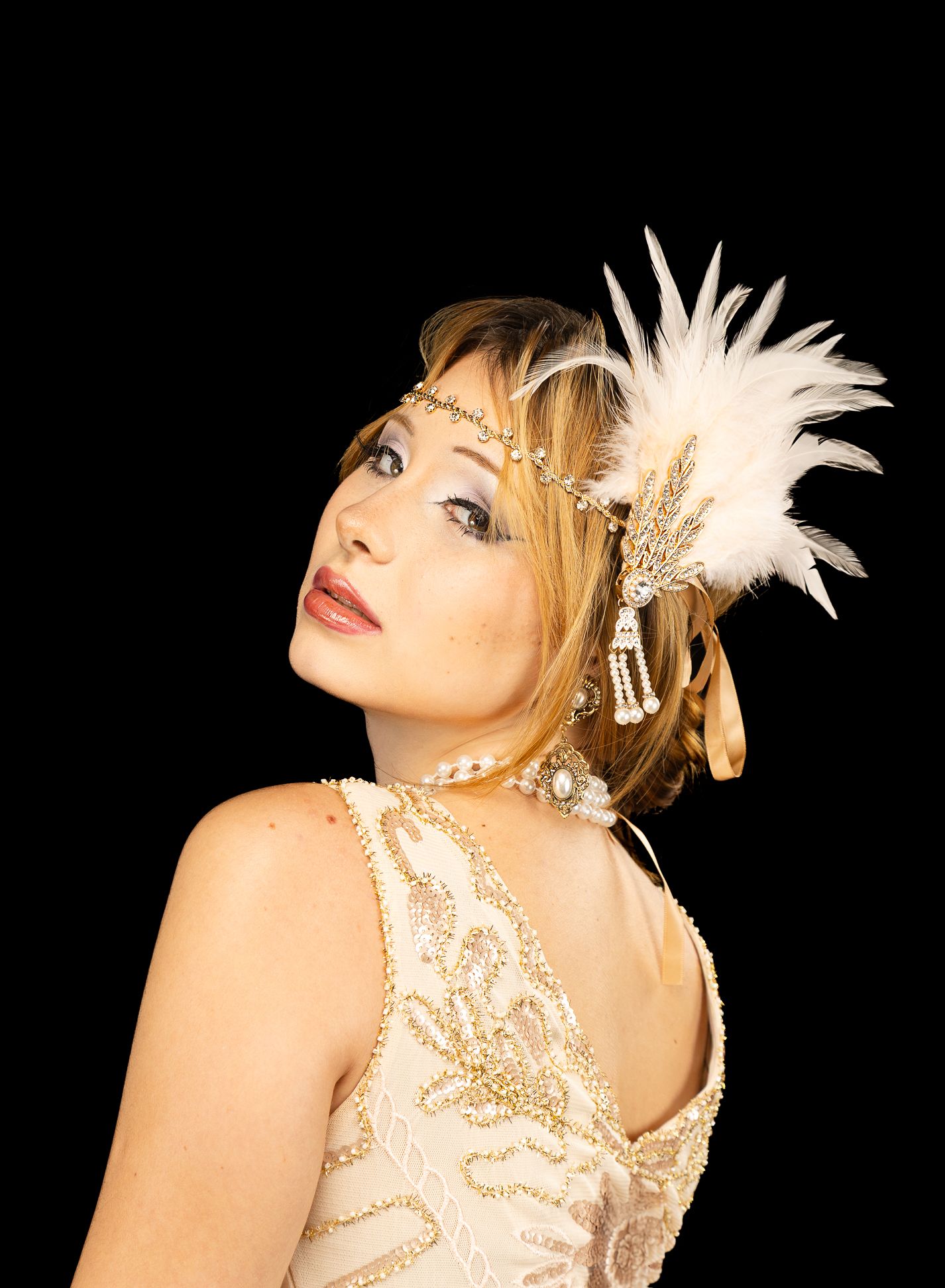 Colour photo of a girl in a flapper costume, looking direct centre