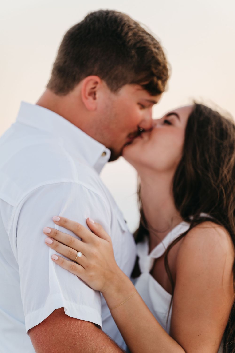 A tender romantic moment captured in close-up on a bright sunny day.