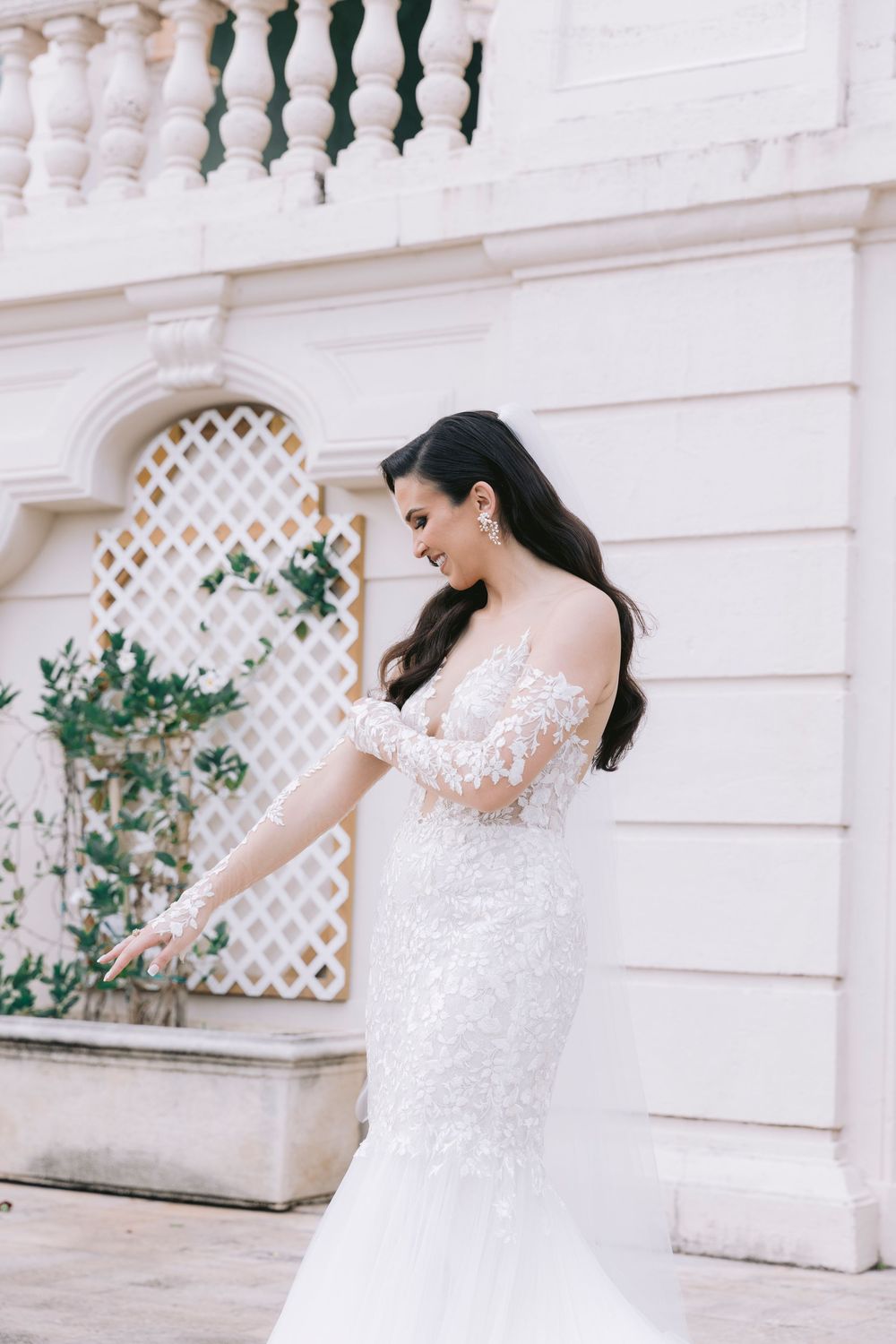 Joyful bridal portraits against ornate white balustrade and lattice details.