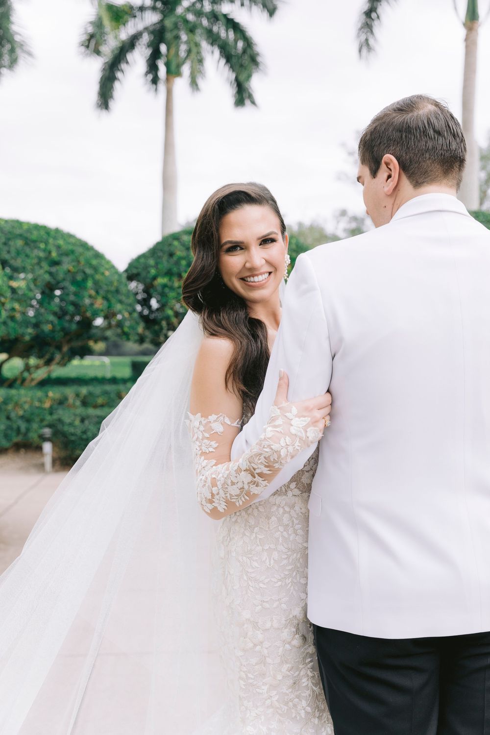Candid wedding moments captured against a tropical palm tree setting.