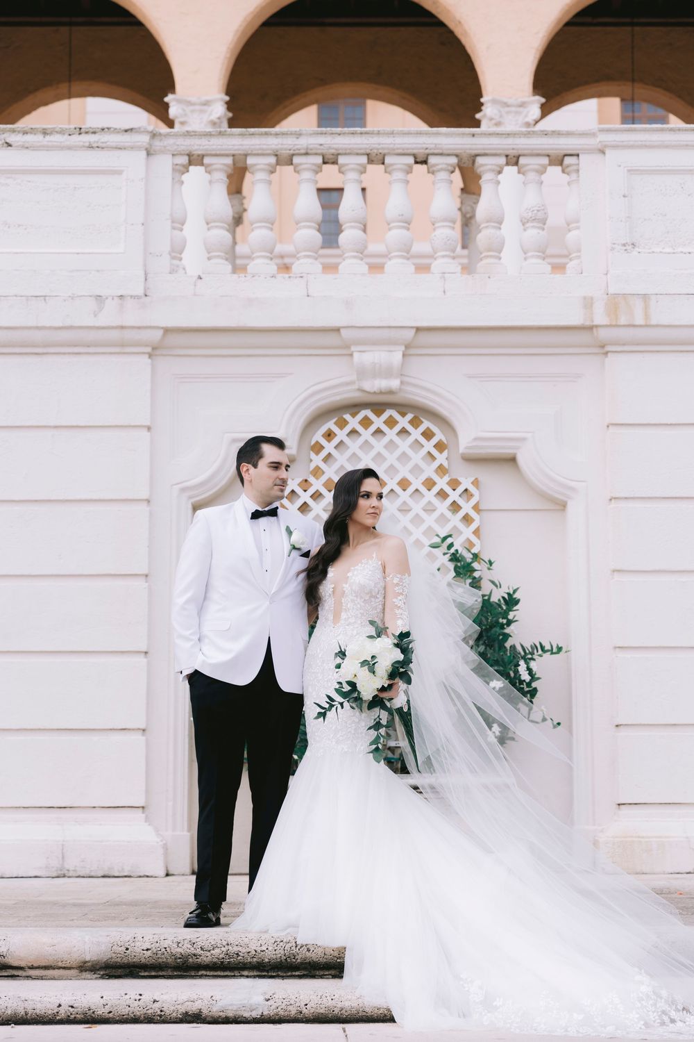 Elegant wedding portraits under white stone archways and columns.