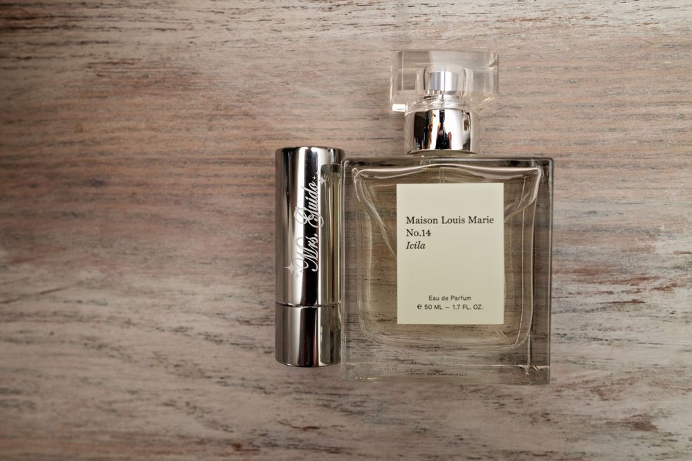 Multiple views of a luxury perfume bottle on a rustic wooden surface showing different angles and reflections.
