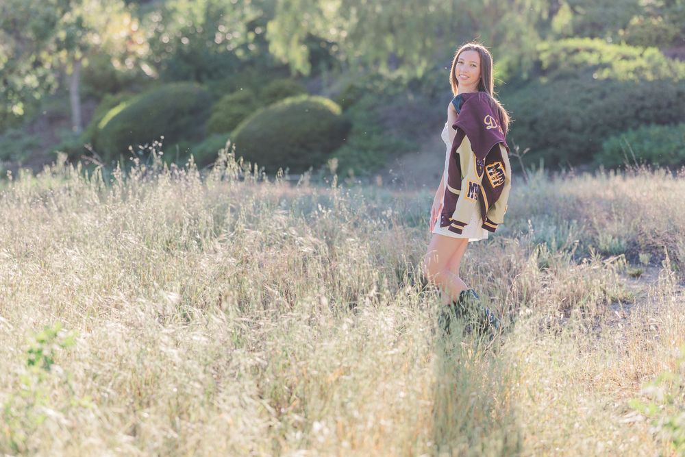 Simi High School twins posing in the hills of Simi Valley for outdoor graduation portraits, celebrating lacrosse and college milestones.