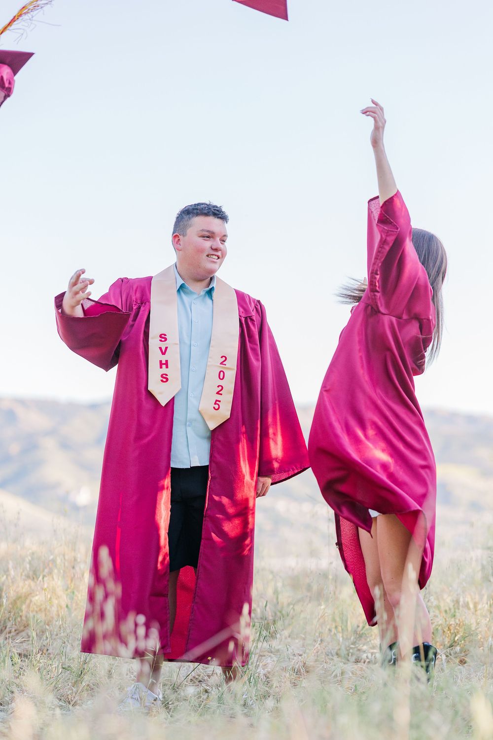 Simi High School twins posing in the hills of Simi Valley for outdoor graduation portraits, celebrating lacrosse and college milestones.