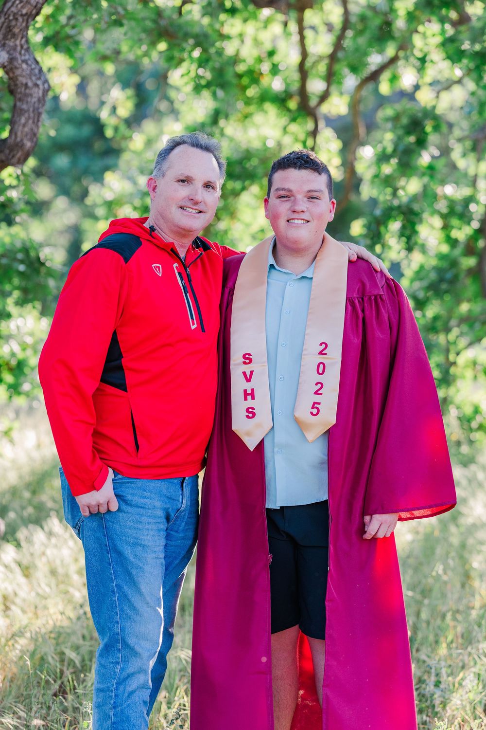 Simi High School twins posing in the hills of Simi Valley for outdoor graduation portraits, celebrating lacrosse and college milestones.