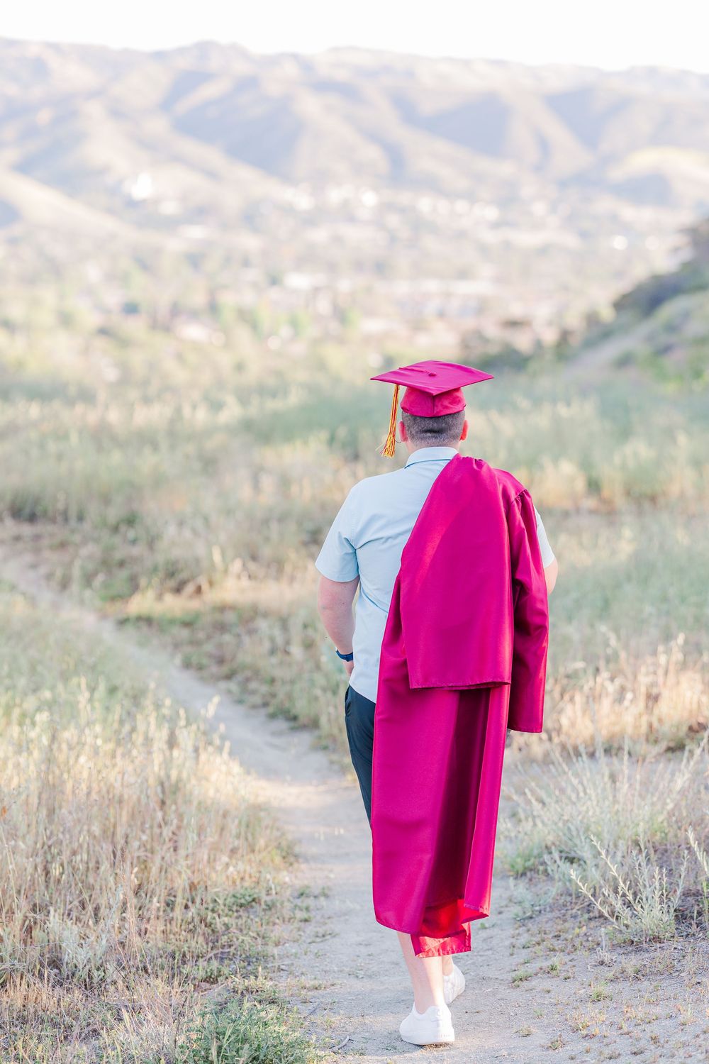 Simi High School twins posing in the hills of Simi Valley for outdoor graduation portraits, celebrating lacrosse and college milestones.