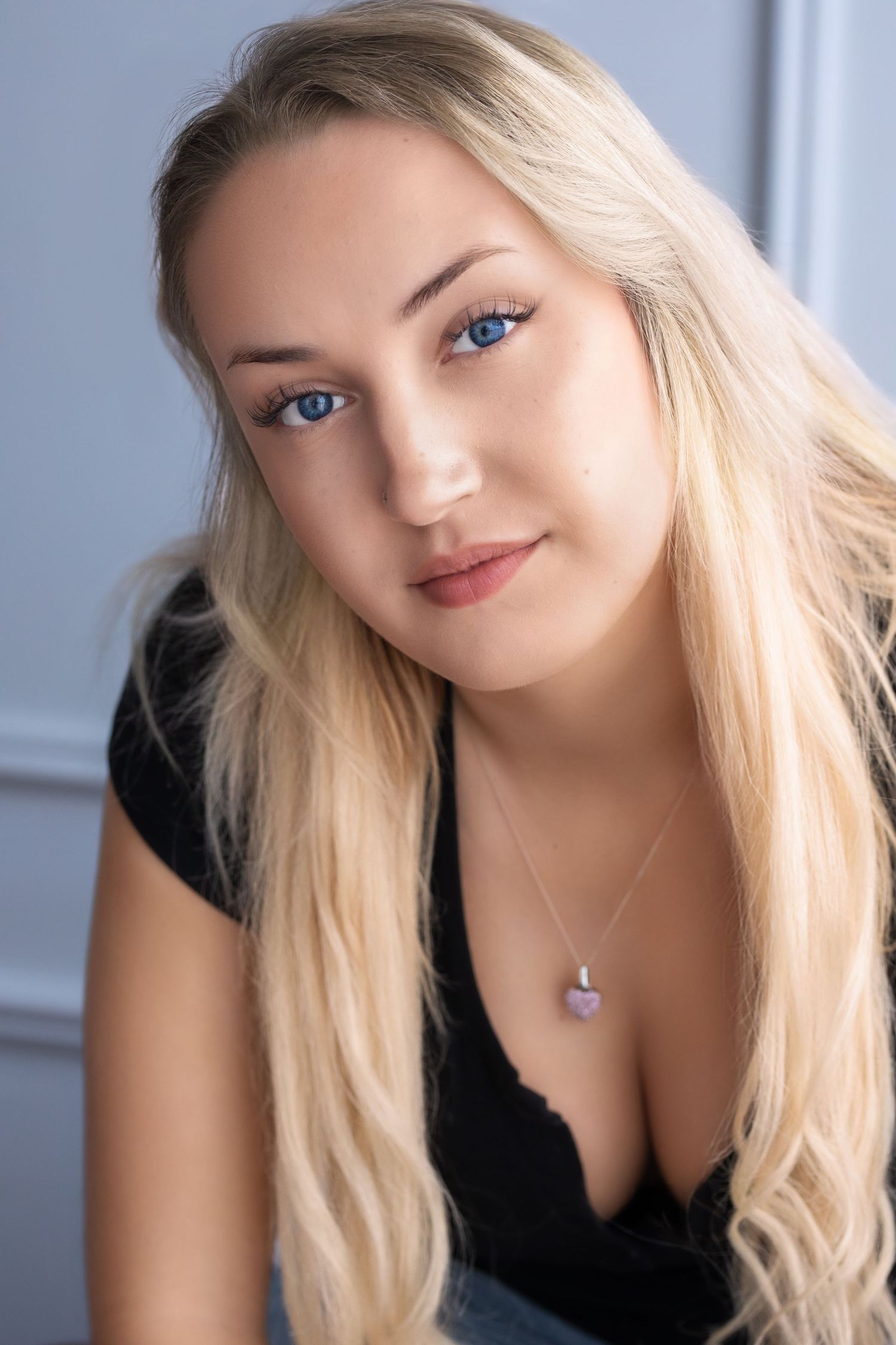 headshot photograph of a young woman with blonde hair and blue eyes