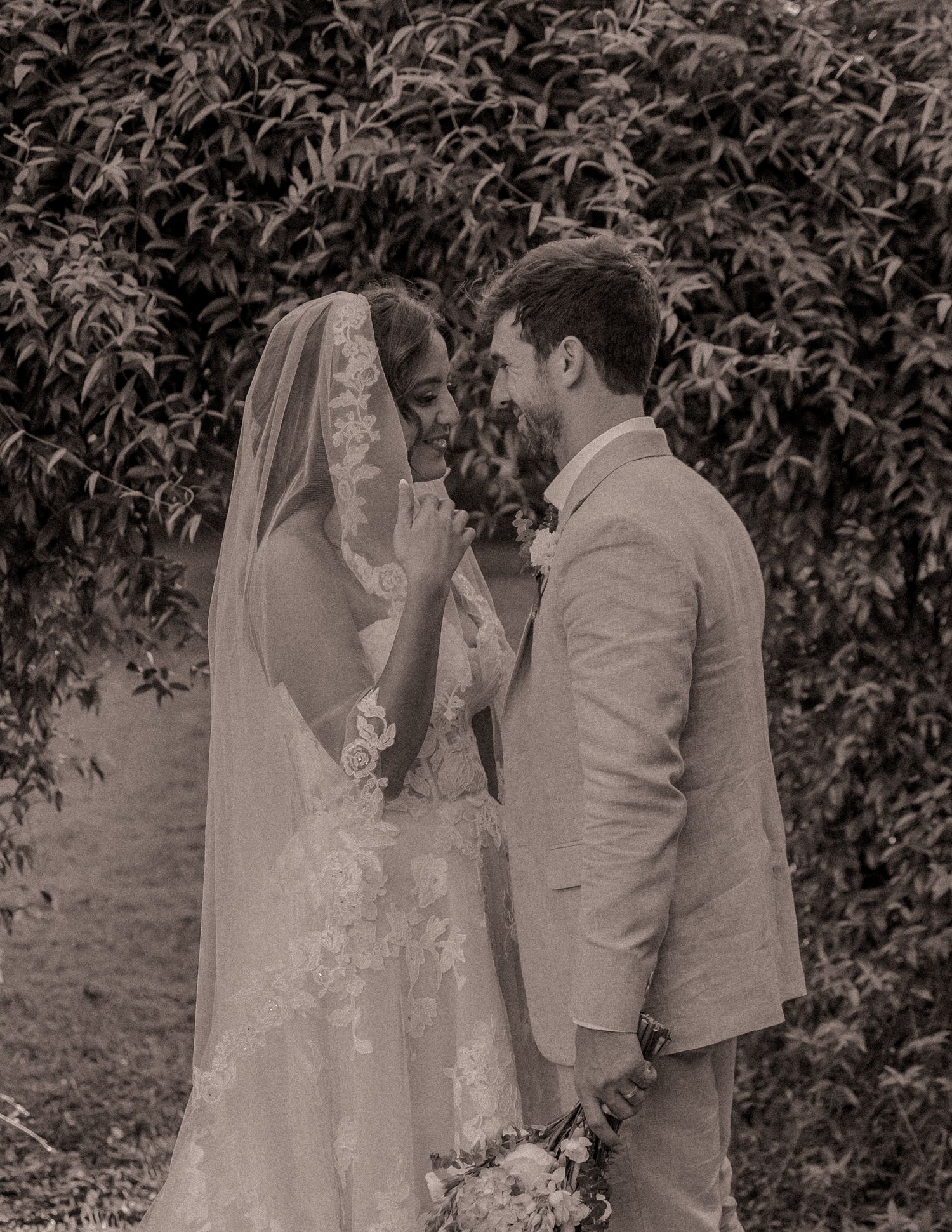Bride and groom sharing a romantic moment under the veil at Farmhouse Siloam in Mount Airy, NC