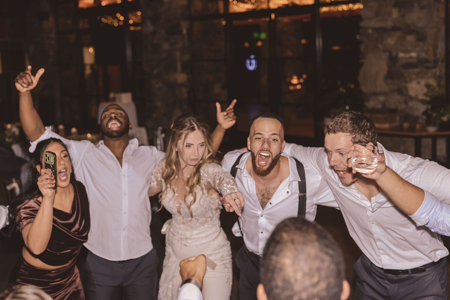 Bride and groom partying with friends during the wedding reception at Omni Grove Park Inn in Asheville, NC