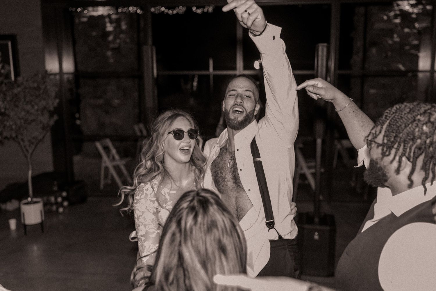 Newlyweds partying with friends during the wedding reception at Omni Grove Park Inn in Asheville, NC