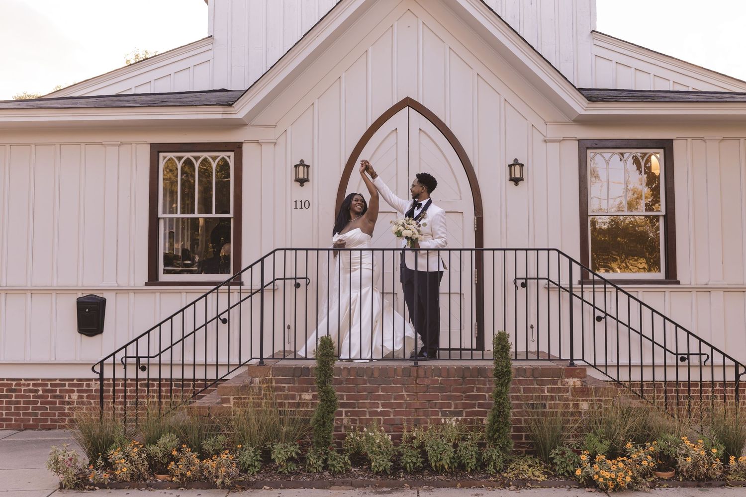 Bride and groom dancing outside the All Saints Chapel in Raleigh, NC