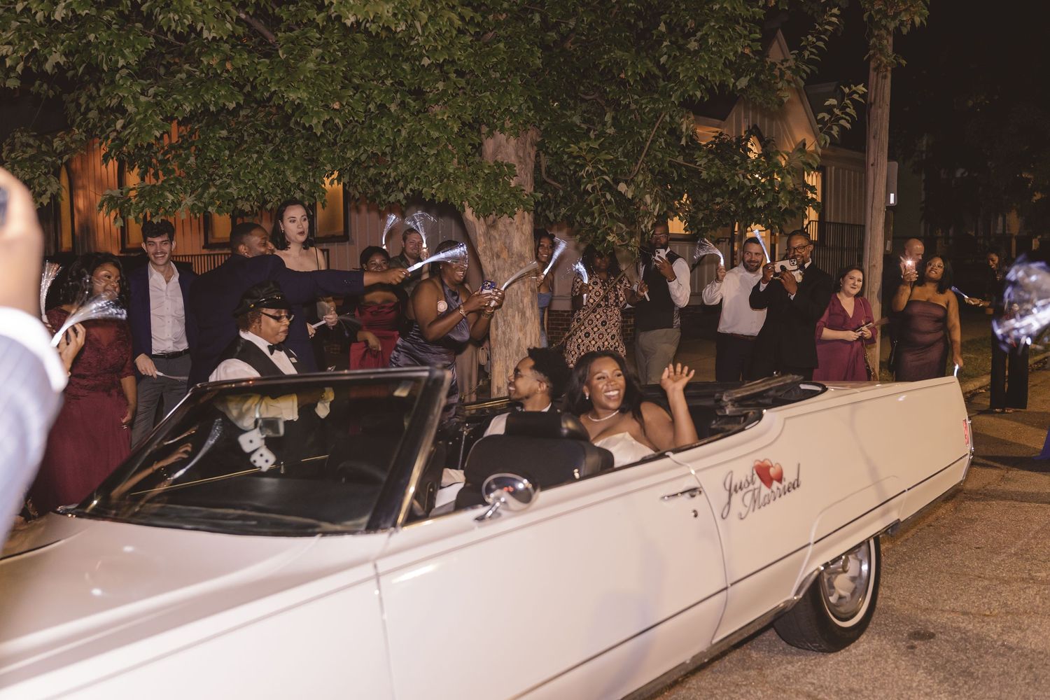 Newlyweds in their getaway car after the wedding reception at All Saints Chapel in Raleigh, NC