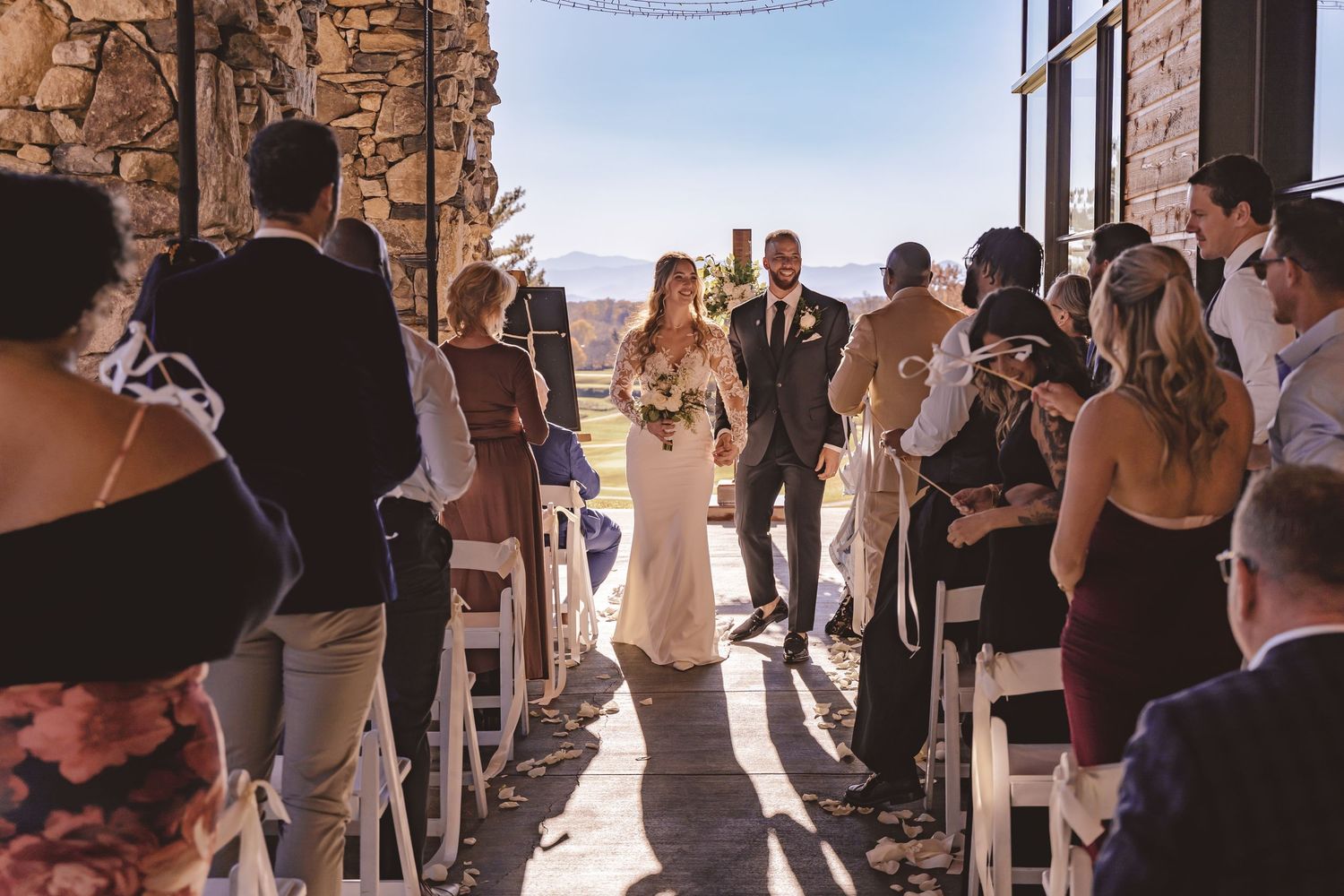 Bride walking down the aisle after wedding ceremony at Omni Grove Park Inn in Asheville, NC