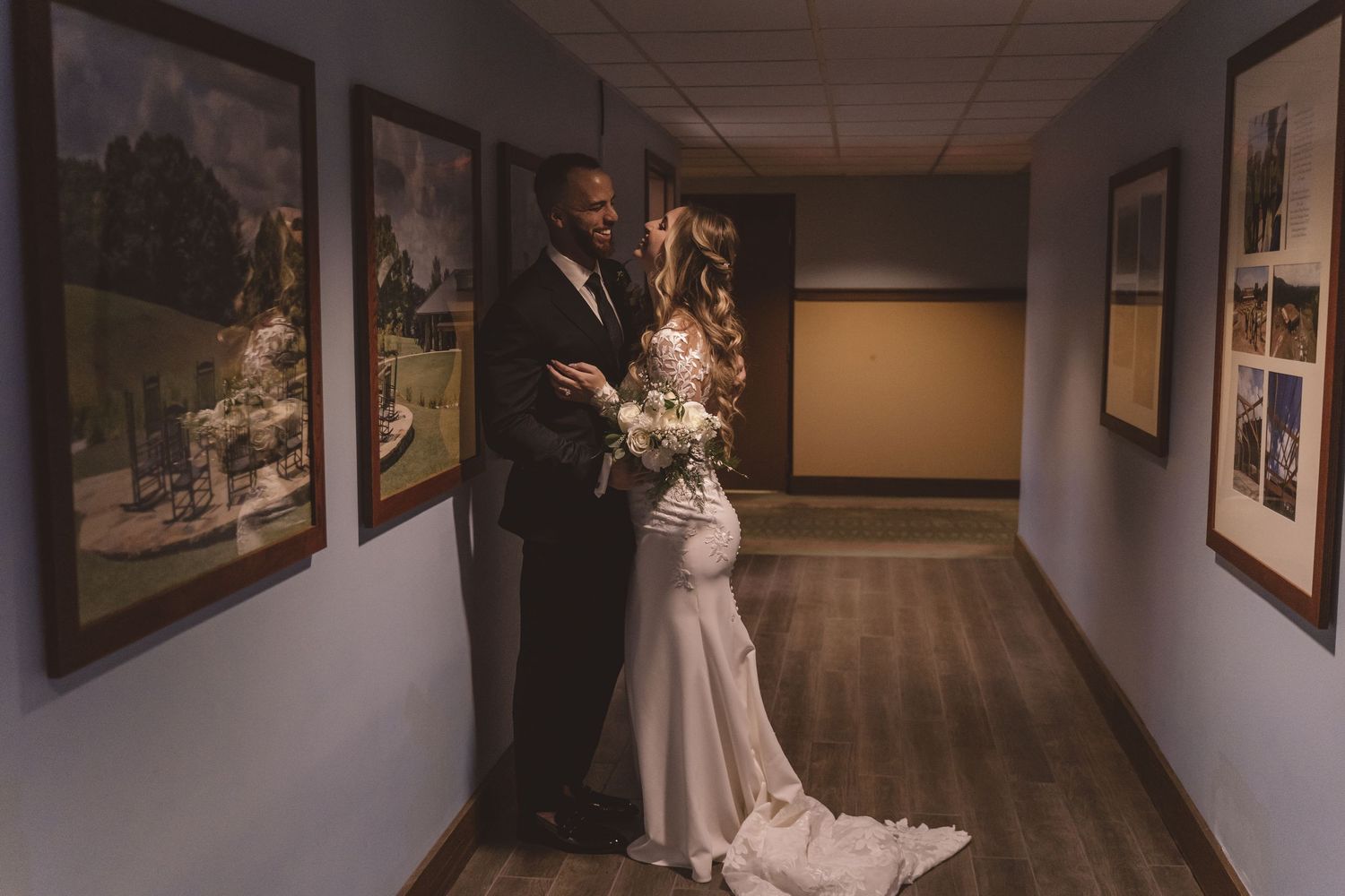 Bride and groom embracing in a hotel hallway at Omni Grove Park Inn in Asheville, NC