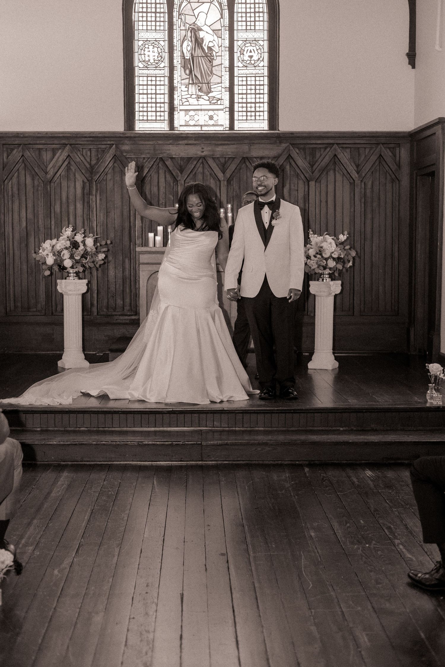 Newlyweds celebrating after the ceremony at All Saint Chapel in Raleigh, NC