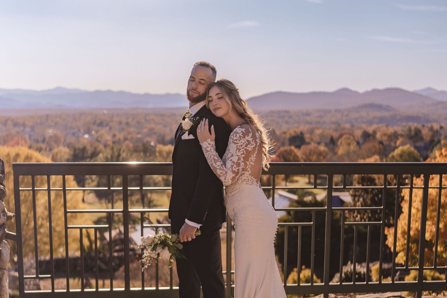 Bride and groom embracing with mountain views at Omni Grove Park Inn in Asheville, NC