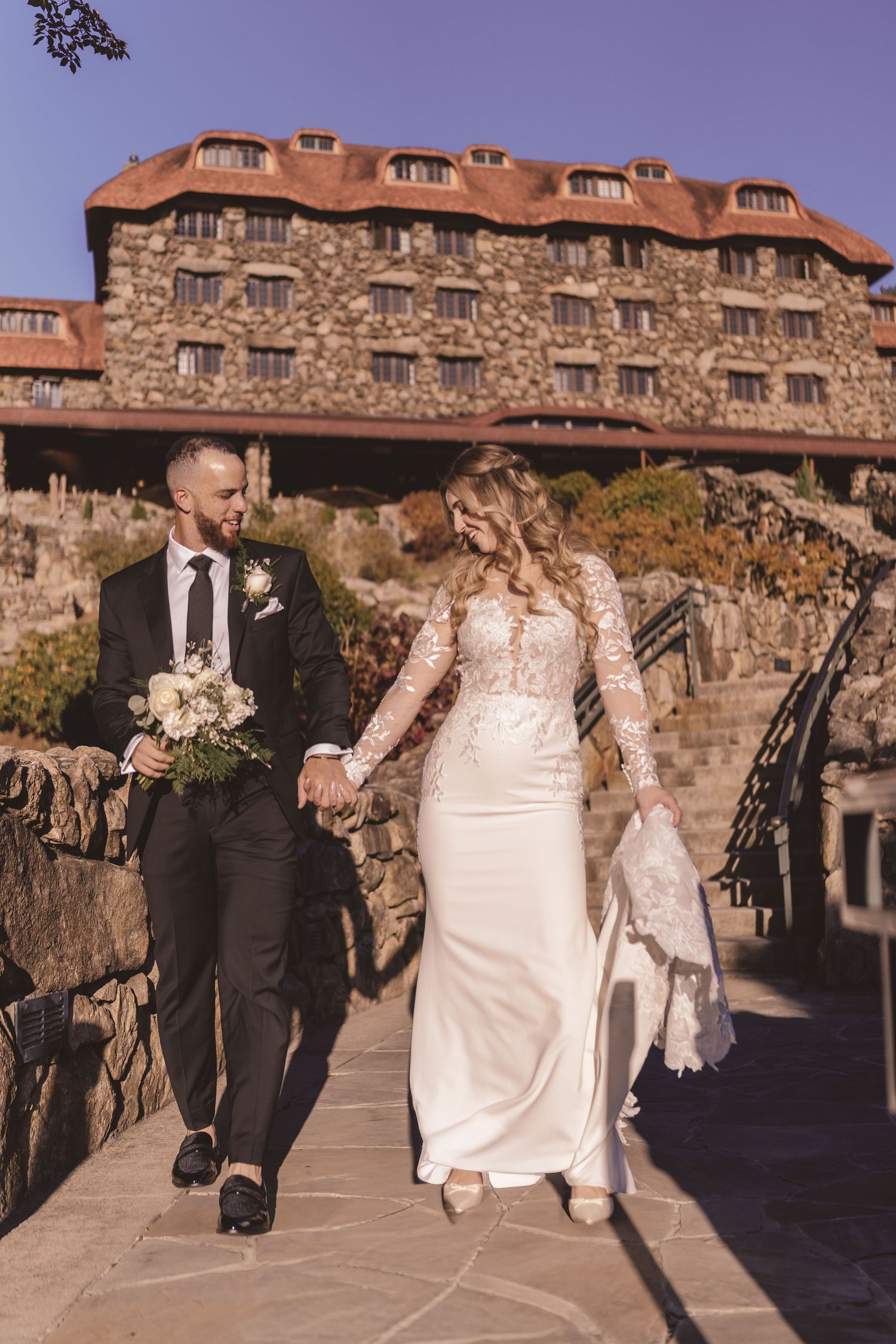 Bride and groom walking together during newlywed portraits at Omni Grove Park Inn in Asheville, NC