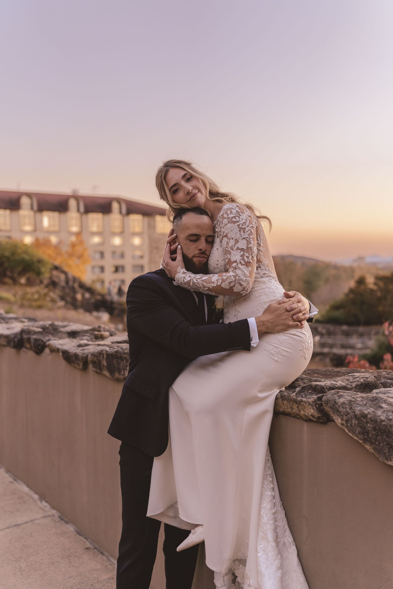 Bride and groom embracing during golden hour at Omni Grove Park Inn in Asheville, NC