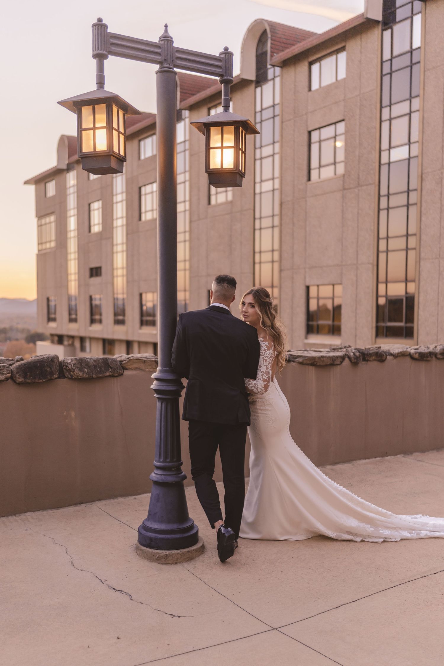 Bride and groom embracing during sunset portraits at Omni Grove Park Inn in Asheville, NC