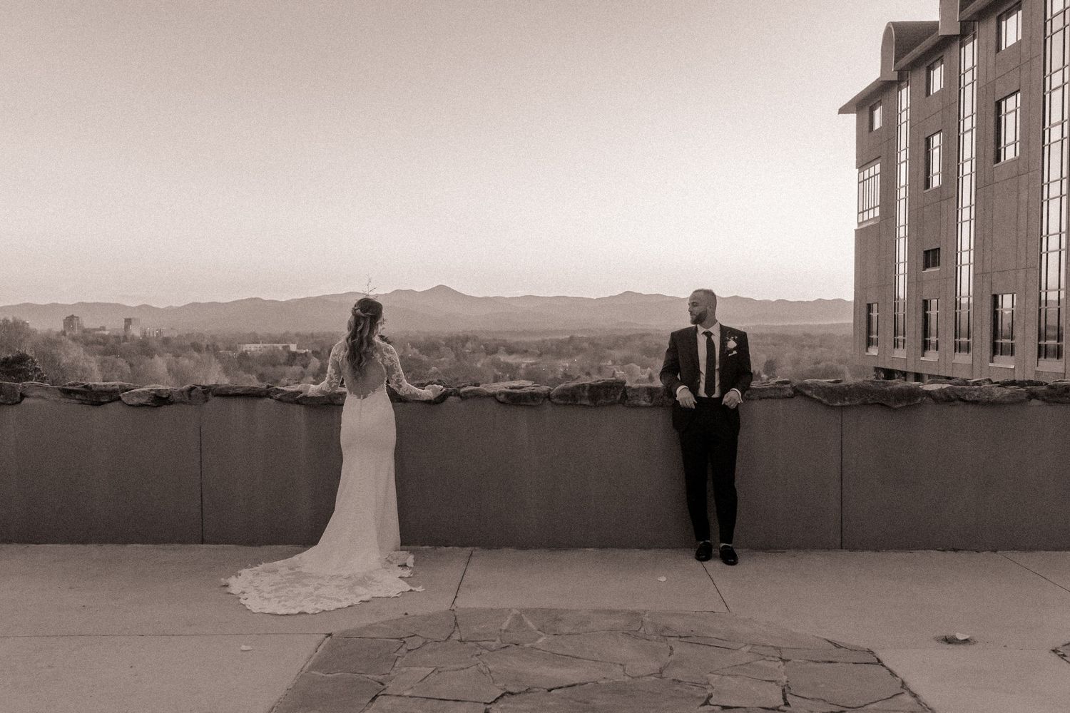 Bride and groom standing apart during sunset portraits at Omni Grove Park Inn in Asheville, NC