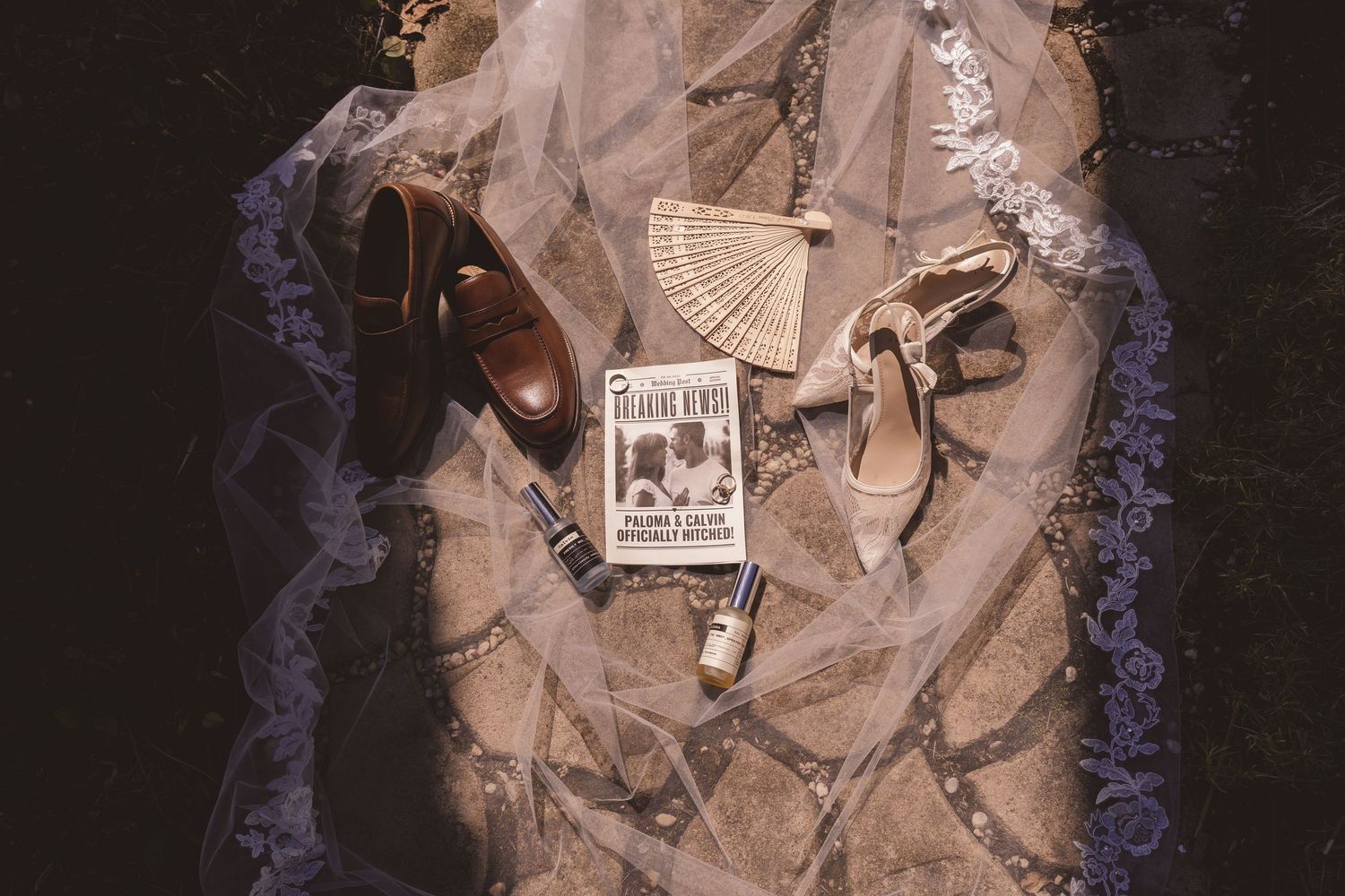 Wedding invitation suite and rings photographed on veil at Farmhouse Siloam in Mount Airy, NC
