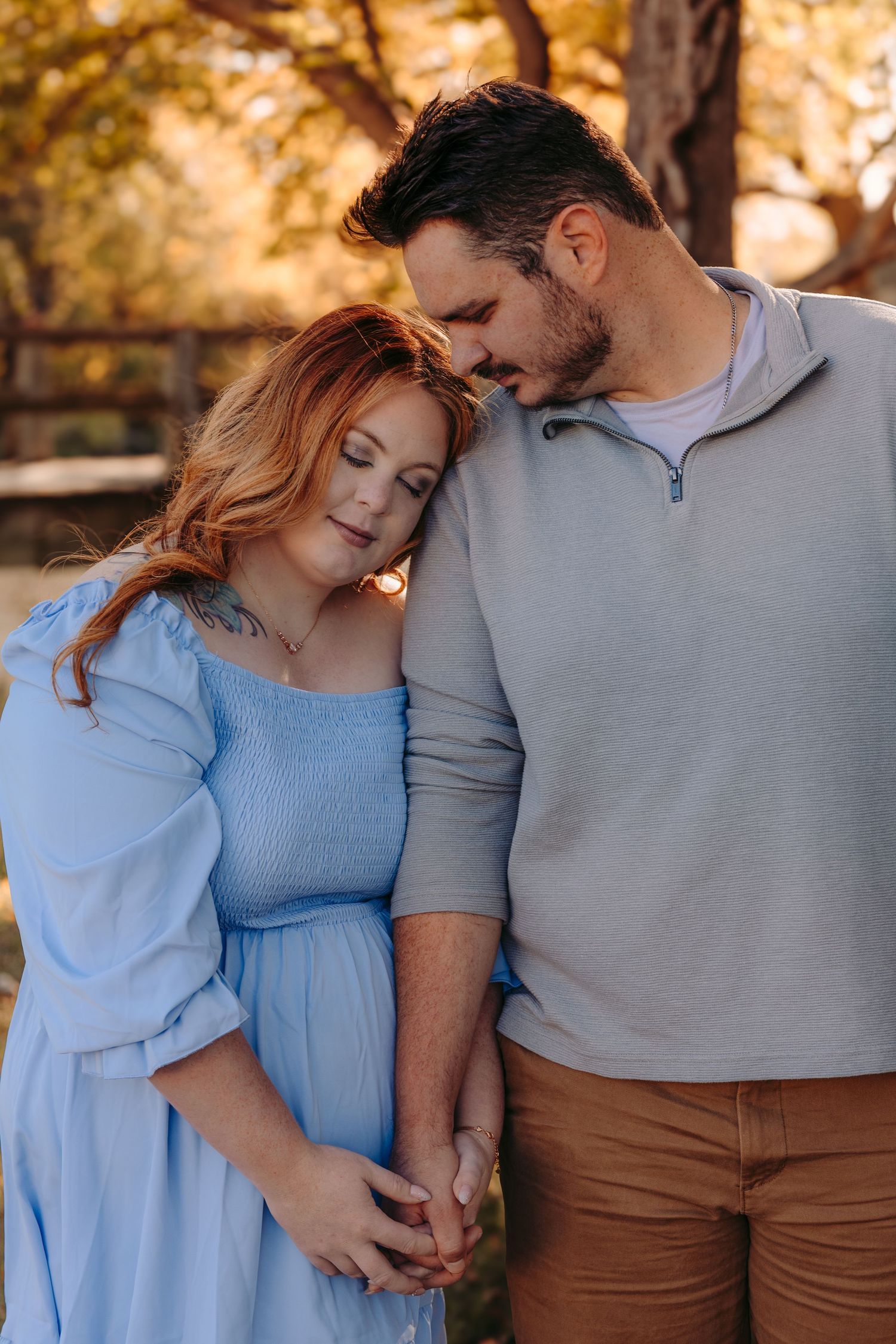 Romantic couple sharing an intimate moment outdoors during golden hour autumn setting.