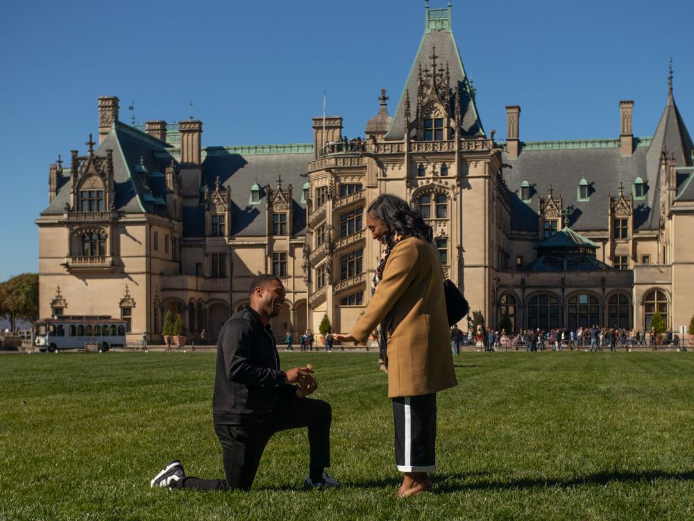 A proposal moment captured with the historic Biltmore Estate as the backdrop.