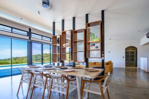 Covered outdoor seating area with BBQ station, perfect for entertaining