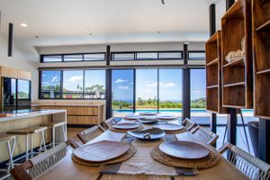Open-concept living space with custom-designed wooden shelving and high ceilings.
