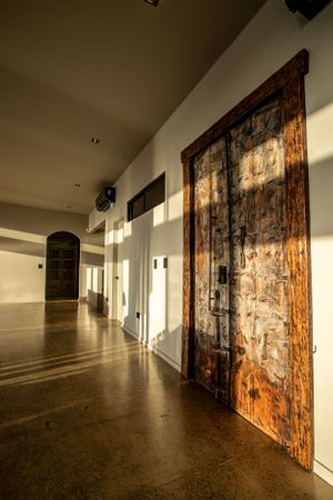 Hallway with stylish lighting fixtures and a unique fusion of modern and rustic elements.