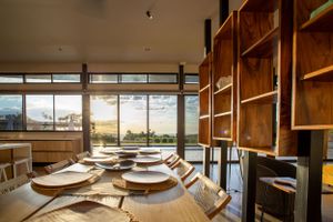 Kitchen with a central island, top-tier appliances, and warm wooden cabinetry.
