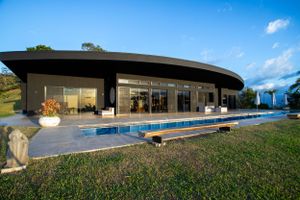 Twilight shot of the illuminated pool area, emphasizing elegant lighting design.