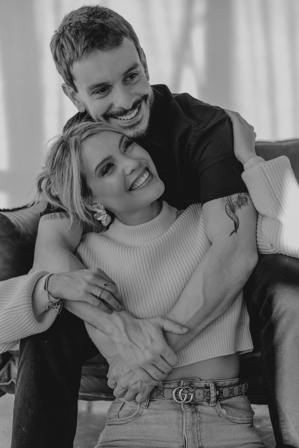 A playful black and white photo series showing a couple laughing and embracing while wearing casual attire.