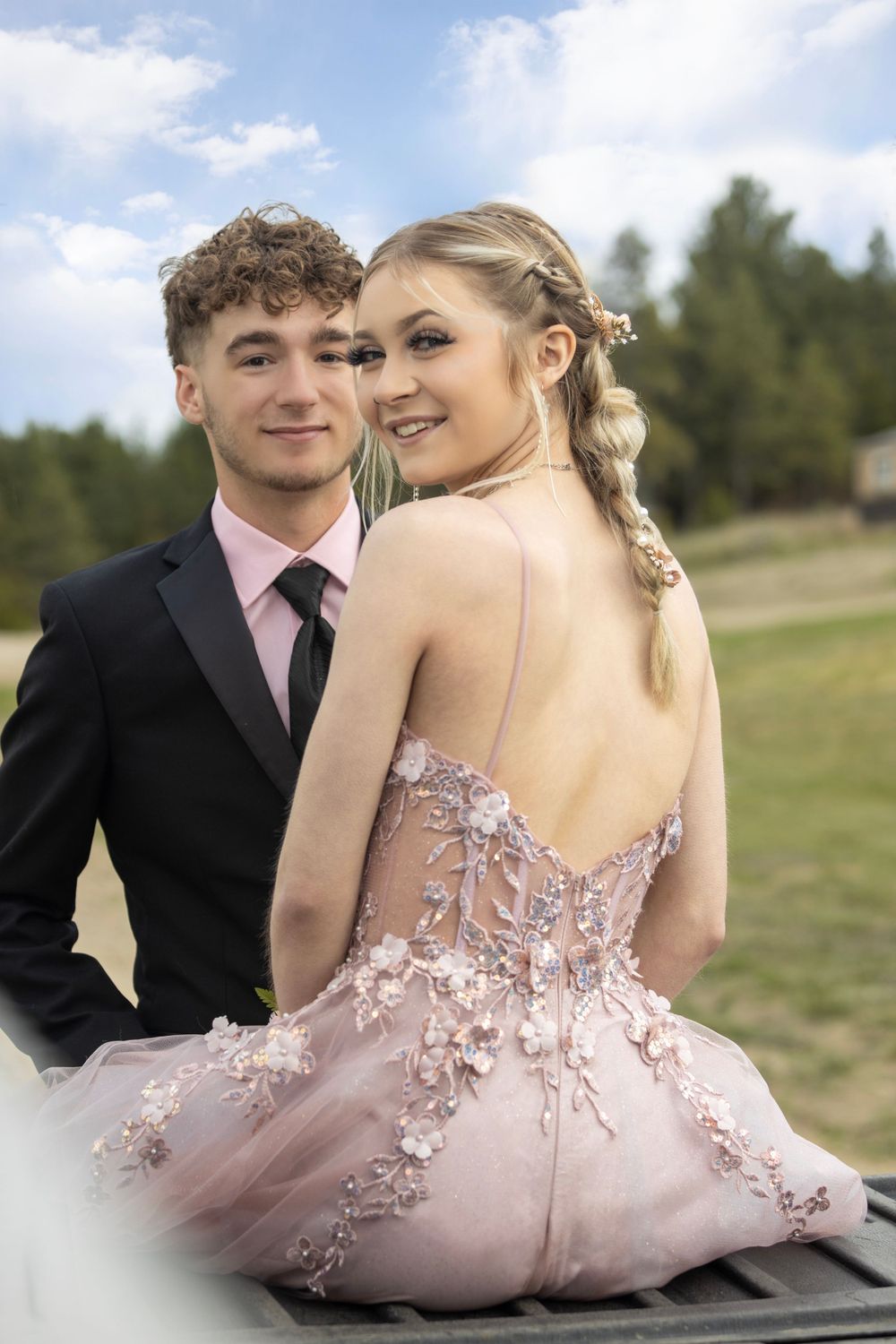 Couple posing for prom portraits.