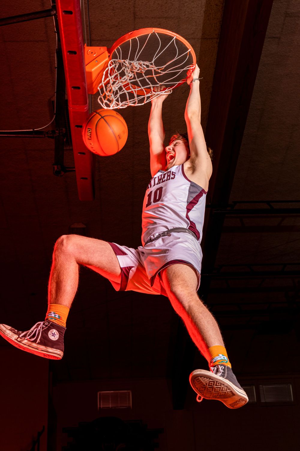 Individual basketball players pose confidently in uniform, capturing strength, focus, and determination in dynamic sports portraits.