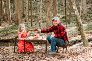 A charming woodland tea party featuring red plaid and polka dots at a rustic table.