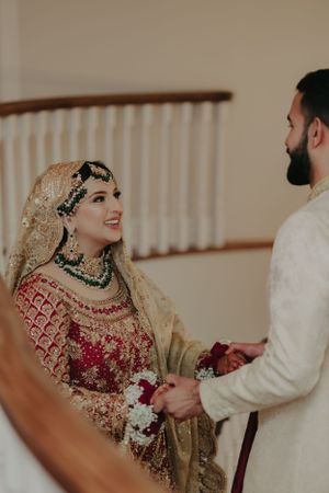 A couple shares a moment during their traditional South Asian wedding ceremony.