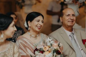 Wedding ceremony guests sharing joyful moments during a beautifully decorated celebration.